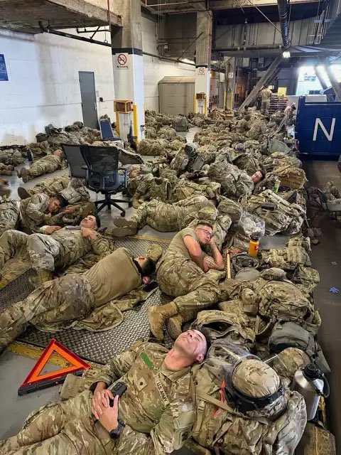 National guard troops sleep on the floor in LA.